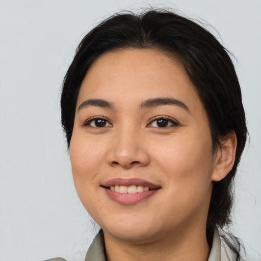 Joyful asian young-adult female with medium  black hair and brown eyes
