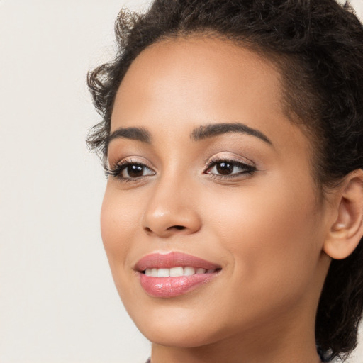 Joyful latino young-adult female with long  brown hair and brown eyes