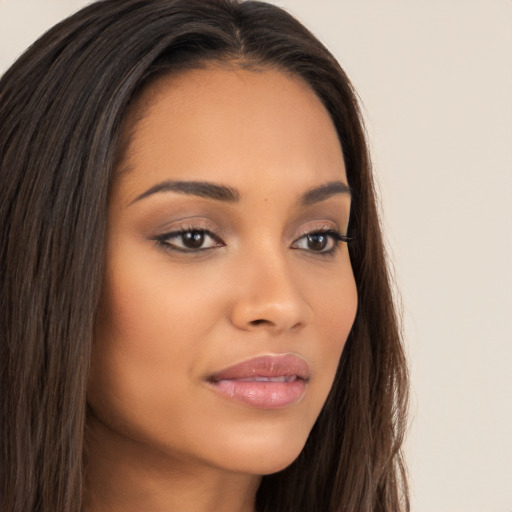 Joyful latino young-adult female with long  brown hair and brown eyes