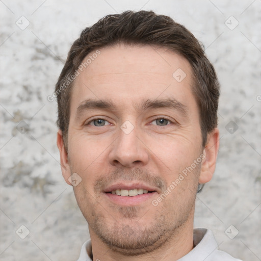 Joyful white adult male with short  brown hair and brown eyes