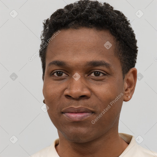 Joyful black young-adult male with short  black hair and brown eyes