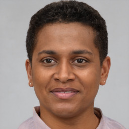 Joyful latino young-adult male with short  brown hair and brown eyes