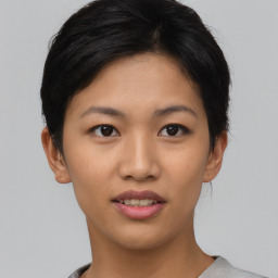 Joyful asian young-adult female with short  brown hair and brown eyes