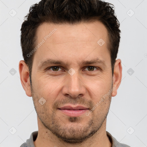 Joyful white adult male with short  brown hair and brown eyes