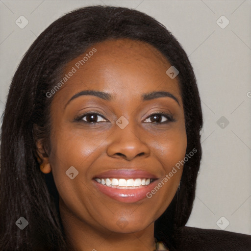 Joyful black young-adult female with long  brown hair and brown eyes