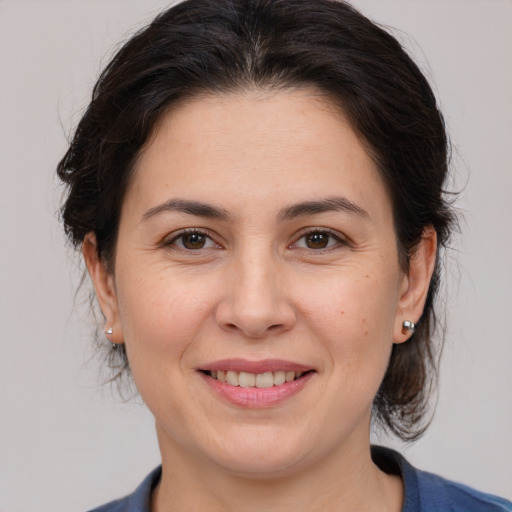 Joyful white adult female with medium  brown hair and brown eyes