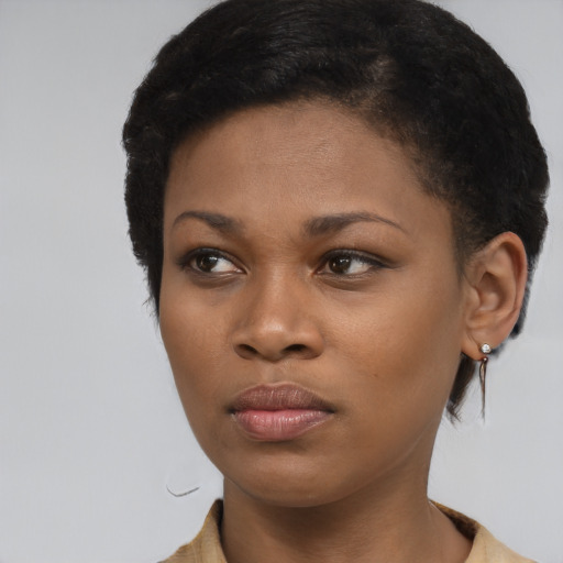 Neutral black young-adult female with medium  brown hair and brown eyes