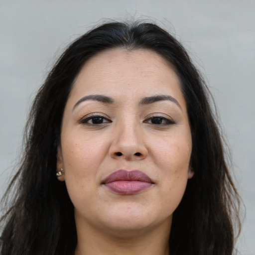 Joyful latino young-adult female with long  brown hair and brown eyes
