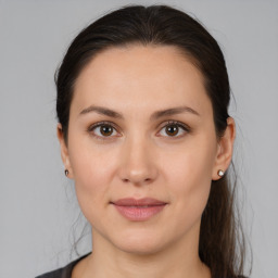 Joyful white young-adult female with medium  brown hair and brown eyes