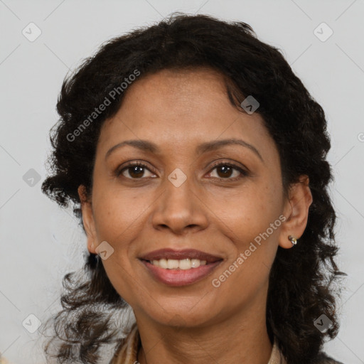 Joyful black adult female with medium  brown hair and brown eyes