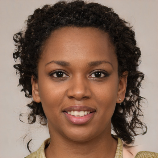 Joyful black young-adult female with medium  brown hair and brown eyes