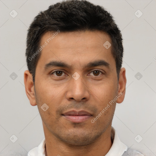 Joyful latino young-adult male with short  brown hair and brown eyes