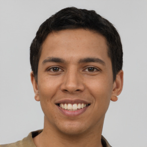 Joyful latino young-adult male with short  brown hair and brown eyes