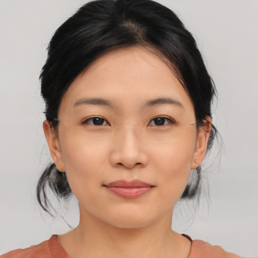 Joyful asian young-adult female with medium  black hair and brown eyes