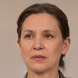 Joyful white adult female with medium  brown hair and grey eyes