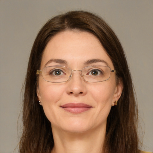 Joyful white adult female with long  brown hair and green eyes