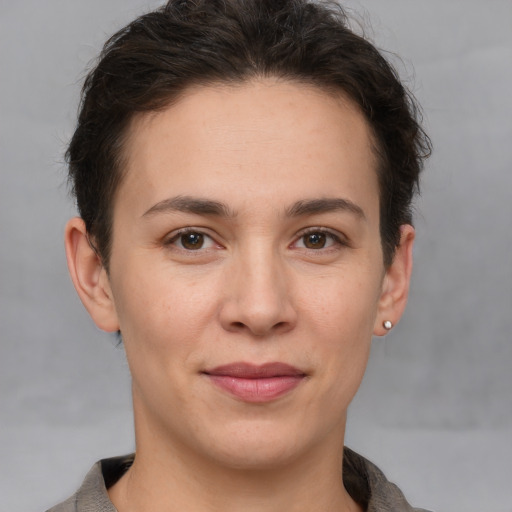 Joyful white young-adult female with short  brown hair and brown eyes