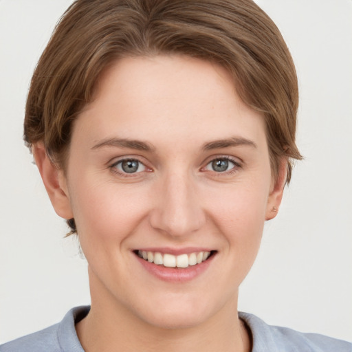 Joyful white young-adult female with short  brown hair and grey eyes