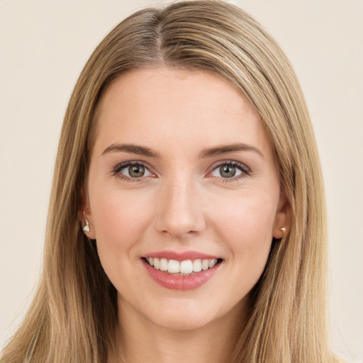 Joyful white young-adult female with long  brown hair and green eyes