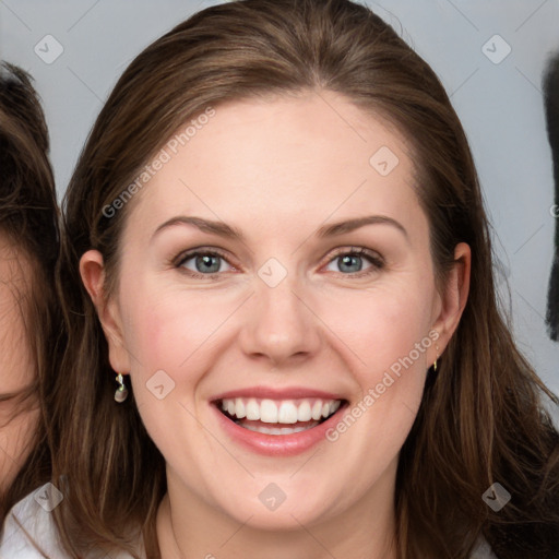 Joyful white young-adult female with long  brown hair and grey eyes