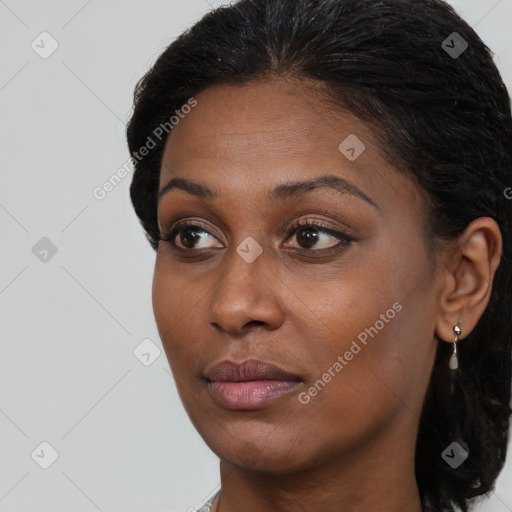 Neutral black young-adult female with medium  brown hair and brown eyes