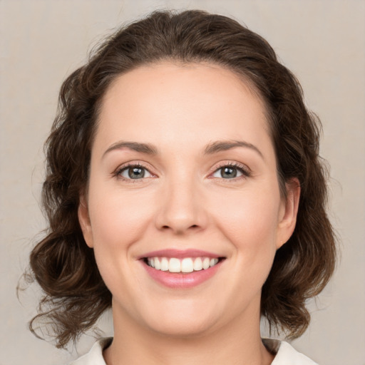 Joyful white young-adult female with medium  brown hair and green eyes