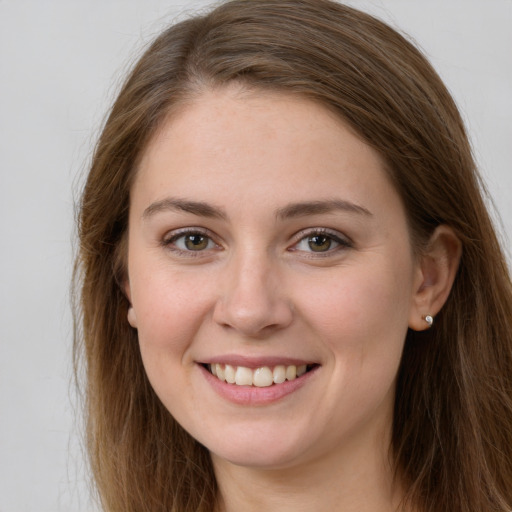 Joyful white young-adult female with long  brown hair and brown eyes