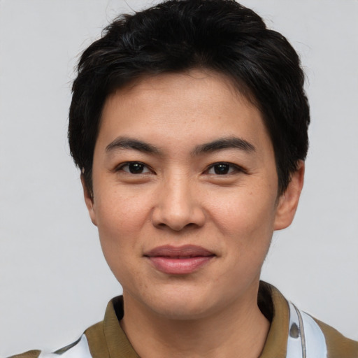 Joyful asian young-adult male with short  black hair and brown eyes