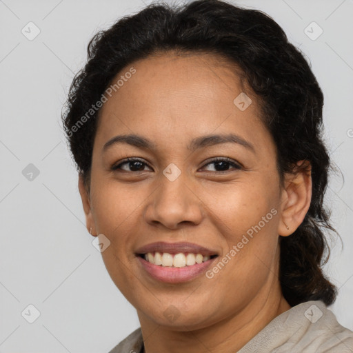 Joyful latino adult female with medium  brown hair and brown eyes