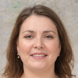 Joyful white adult female with medium  brown hair and grey eyes