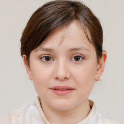 Joyful white child female with medium  brown hair and brown eyes