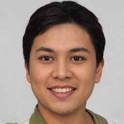 Joyful asian young-adult male with short  black hair and brown eyes