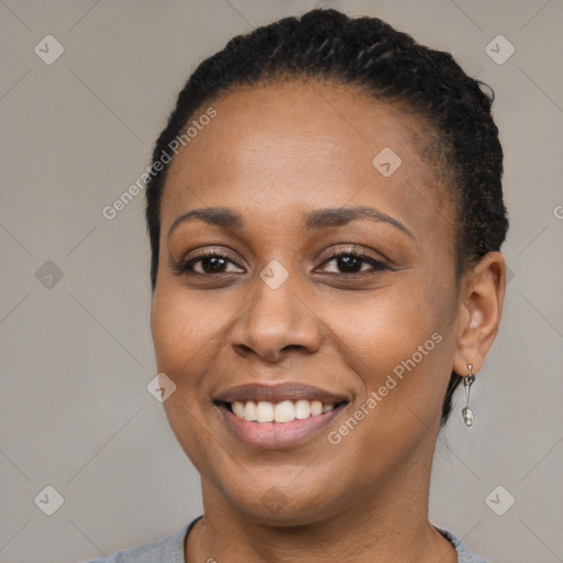 Joyful black young-adult female with short  black hair and brown eyes