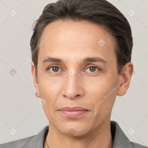 Joyful white adult male with short  brown hair and brown eyes