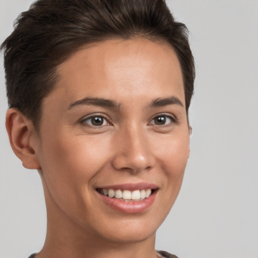 Joyful white young-adult female with short  brown hair and brown eyes