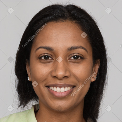 Joyful black young-adult female with long  brown hair and brown eyes