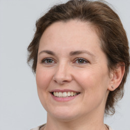 Joyful white adult female with medium  brown hair and brown eyes