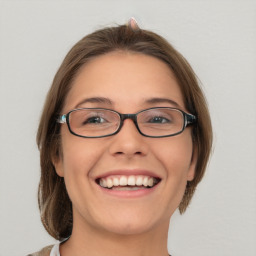 Joyful white young-adult female with medium  brown hair and brown eyes