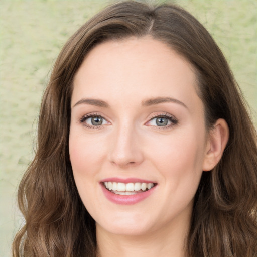 Joyful white young-adult female with long  brown hair and green eyes