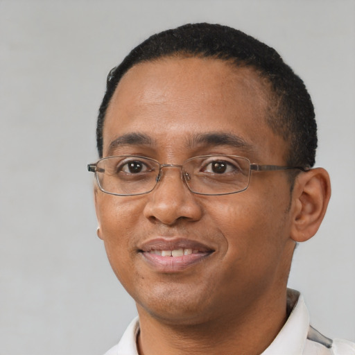 Joyful black adult male with short  black hair and brown eyes
