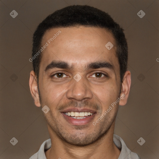 Joyful white young-adult male with short  black hair and brown eyes