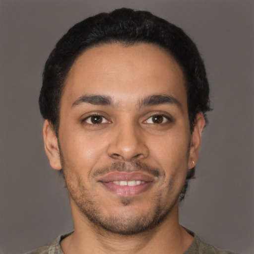 Joyful latino young-adult male with short  black hair and brown eyes