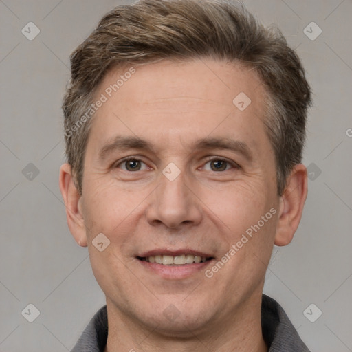 Joyful white adult male with short  brown hair and grey eyes