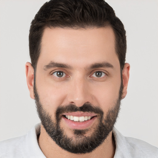 Joyful white young-adult male with short  brown hair and brown eyes