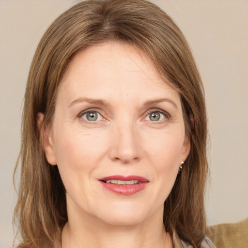 Joyful white adult female with medium  brown hair and grey eyes