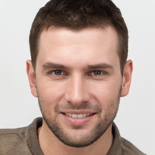 Joyful white young-adult male with short  brown hair and brown eyes