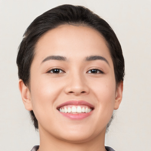 Joyful white young-adult female with medium  brown hair and brown eyes