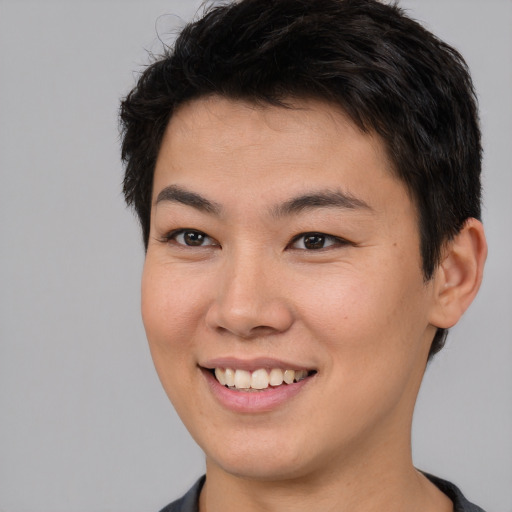 Joyful asian young-adult male with short  brown hair and brown eyes