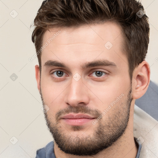 Neutral white young-adult male with short  brown hair and brown eyes