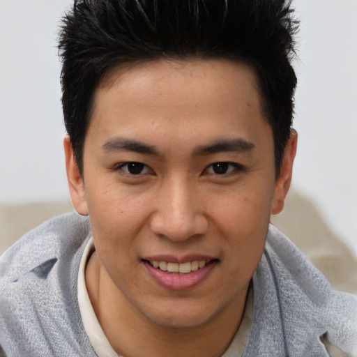 Joyful asian young-adult male with short  brown hair and brown eyes